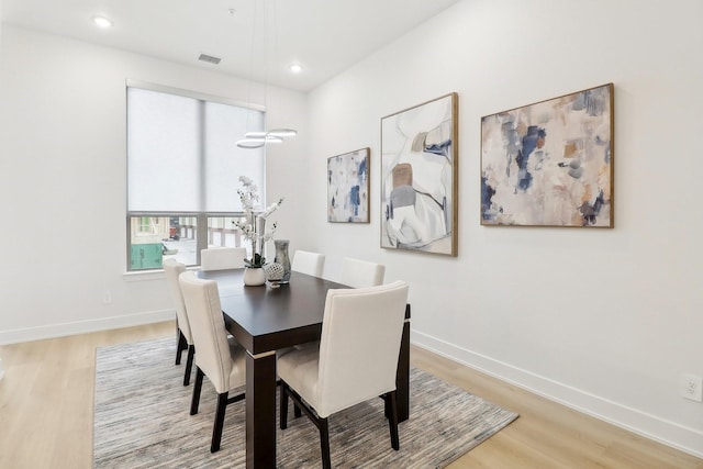 dining space featuring light wood-type flooring, visible vents, baseboards, and recessed lighting