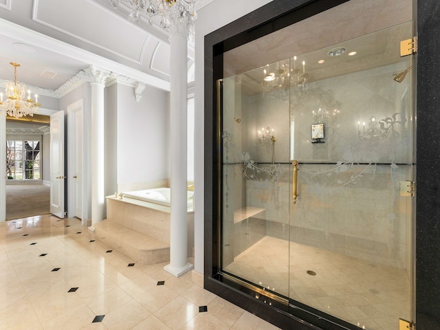 full bathroom with tile patterned floors, a garden tub, a notable chandelier, a stall shower, and ornate columns