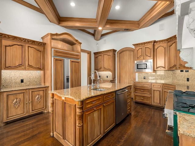 kitchen featuring a sink, built in appliances, an island with sink, coffered ceiling, and dark wood-style flooring