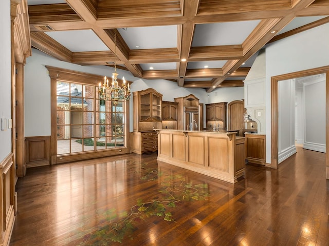 kitchen with a center island with sink, coffered ceiling, an inviting chandelier, open shelves, and beam ceiling