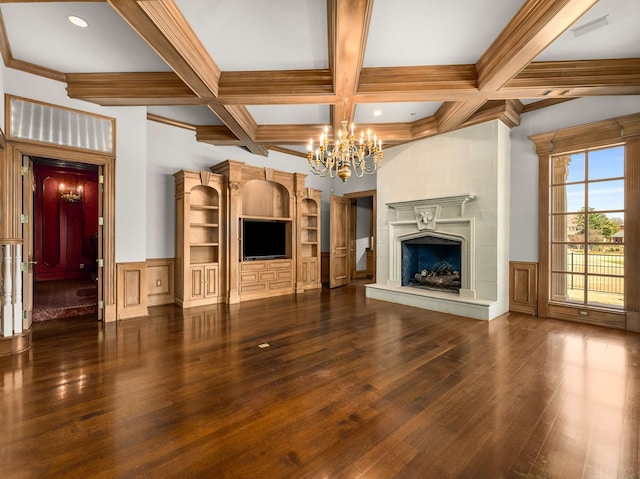 unfurnished living room featuring a wainscoted wall, beam ceiling, wood finished floors, a notable chandelier, and coffered ceiling