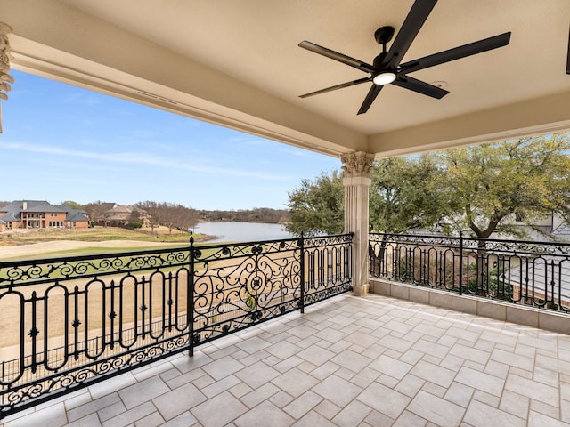 view of patio / terrace with a balcony, a water view, and ceiling fan