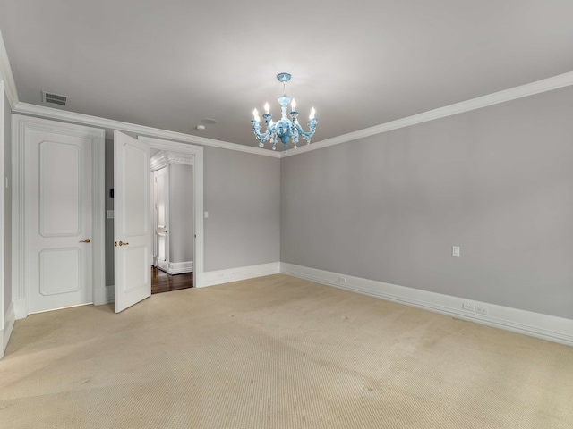 carpeted empty room with visible vents, baseboards, a chandelier, and crown molding