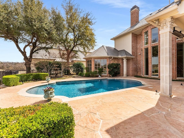 view of pool with a fenced in pool, a patio area, and fence