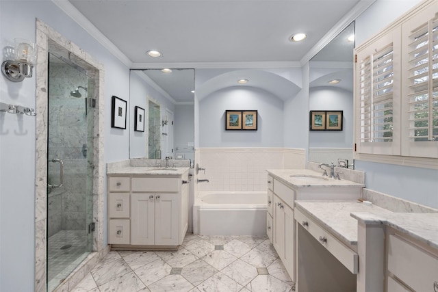 bathroom with crown molding, a sink, and a shower stall