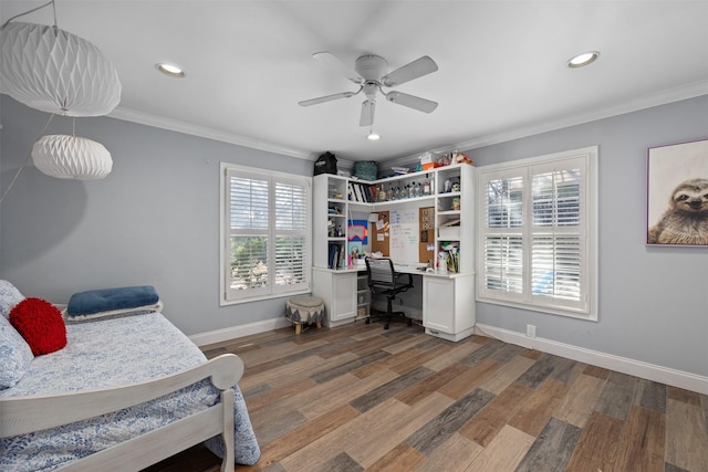 bedroom with baseboards, ceiling fan, wood finished floors, and crown molding