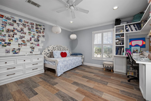 bedroom with ornamental molding, visible vents, baseboards, and wood finished floors