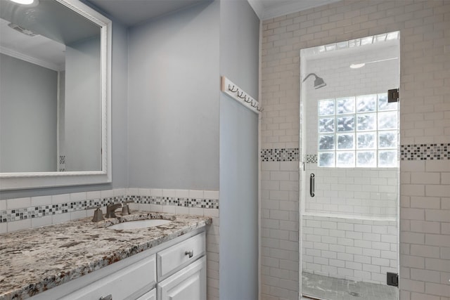 bathroom featuring ornamental molding, a stall shower, and vanity