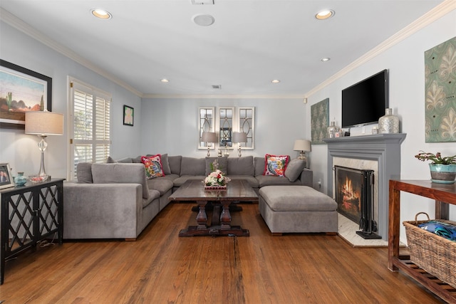 living area featuring ornamental molding, a fireplace, wood finished floors, and recessed lighting