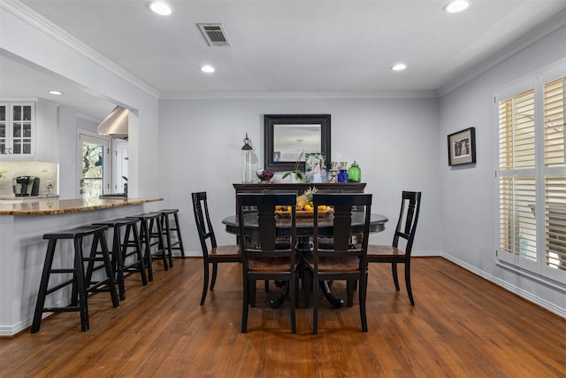 dining space with ornamental molding, recessed lighting, visible vents, and dark wood-style floors