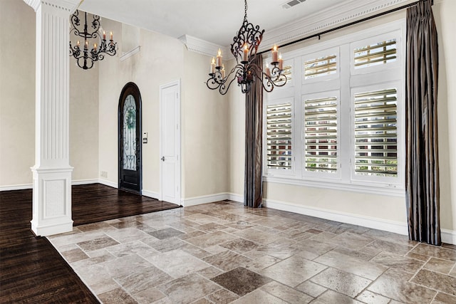 foyer entrance with arched walkways, baseboards, decorative columns, and stone tile floors