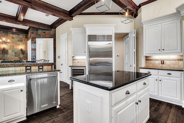 kitchen with white cabinets, coffered ceiling, appliances with stainless steel finishes, dark wood-style flooring, and beam ceiling