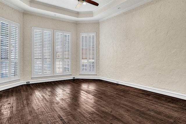 empty room featuring ceiling fan, crown molding, wood finished floors, and a textured wall