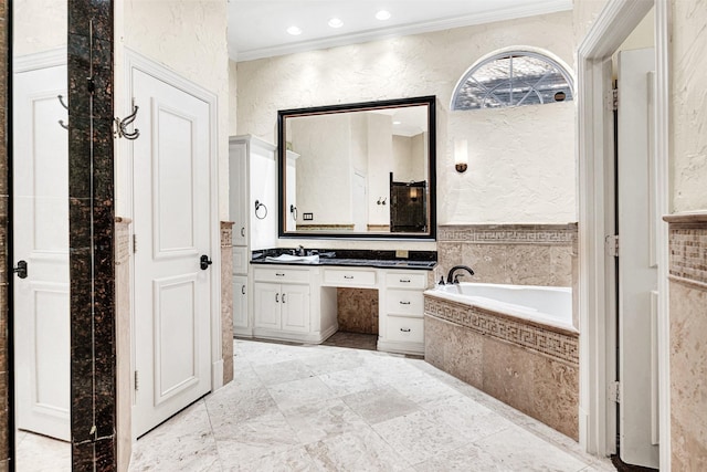 bathroom with a textured wall, a garden tub, crown molding, vanity, and recessed lighting