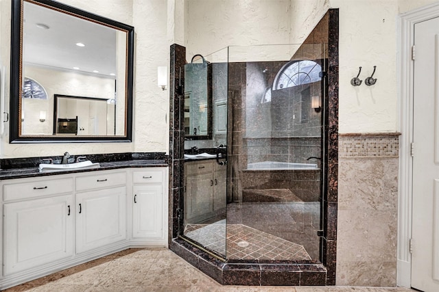 full bath featuring a shower stall and a textured wall