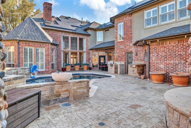 view of pool with area for grilling, a swimming pool, and a patio area