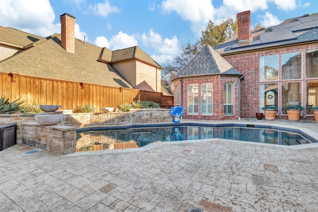 view of pool with a fenced in pool, a patio area, and fence