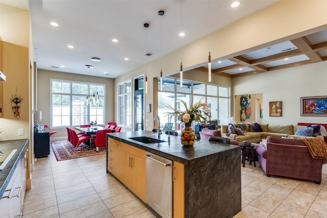 kitchen featuring coffered ceiling, dishwasher, dark countertops, open floor plan, and a sink