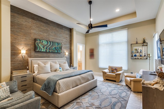 tiled bedroom featuring recessed lighting, an accent wall, a ceiling fan, baseboards, and a tray ceiling