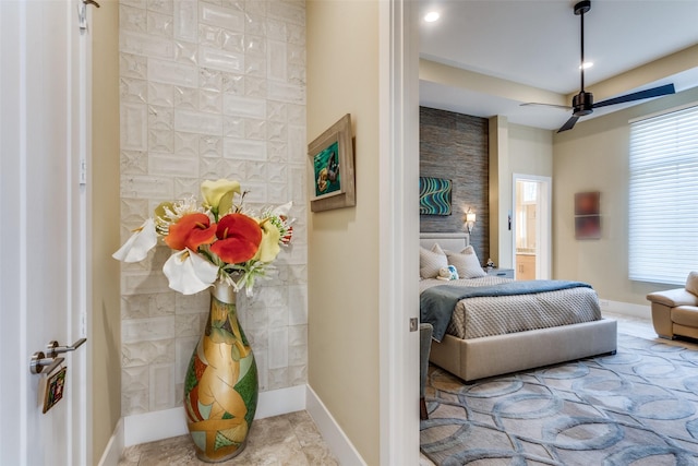 bedroom with an accent wall, recessed lighting, and baseboards