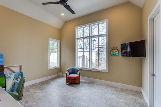 living area with plenty of natural light, baseboards, and vaulted ceiling