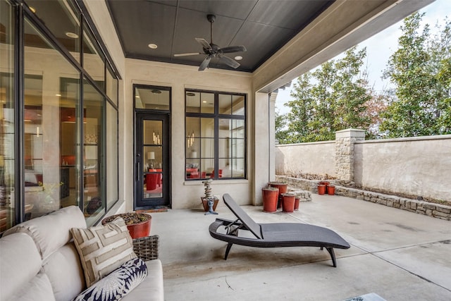 view of patio featuring ceiling fan, fence, and an outdoor hangout area