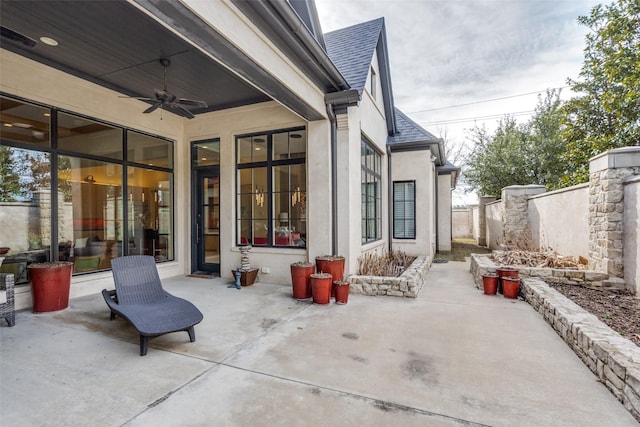 view of patio / terrace featuring ceiling fan and fence