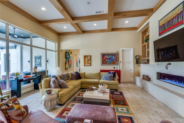 living area featuring coffered ceiling, visible vents, built in features, beamed ceiling, and a glass covered fireplace