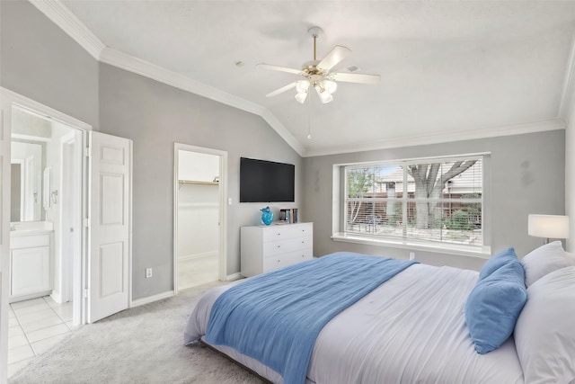 bedroom with lofted ceiling, ornamental molding, a walk in closet, and light colored carpet