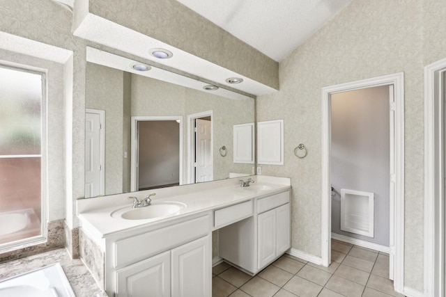 full bath with tile patterned flooring, vaulted ceiling, a sink, and double vanity