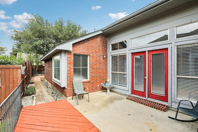 wooden deck featuring a patio and a fenced backyard