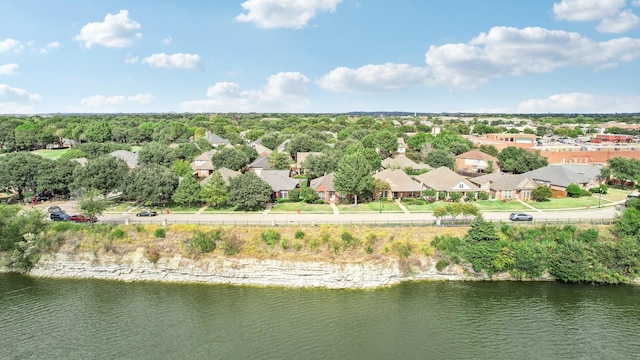 drone / aerial view featuring a water view and a residential view