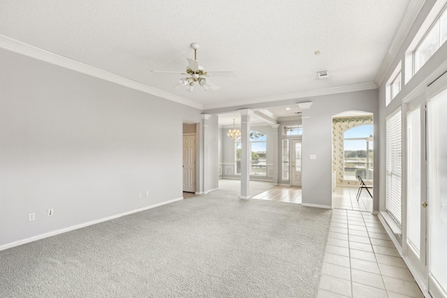 unfurnished room featuring a wealth of natural light, light carpet, crown molding, and light tile patterned floors