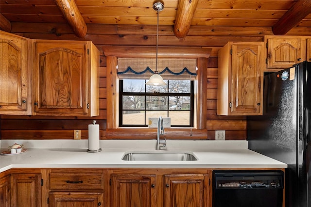 kitchen featuring beam ceiling, light countertops, a sink, wooden ceiling, and black appliances