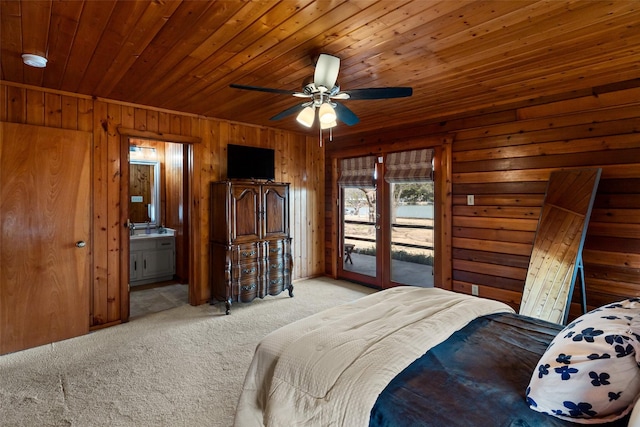 bedroom featuring ensuite bathroom, wooden walls, light carpet, wood ceiling, and access to outside