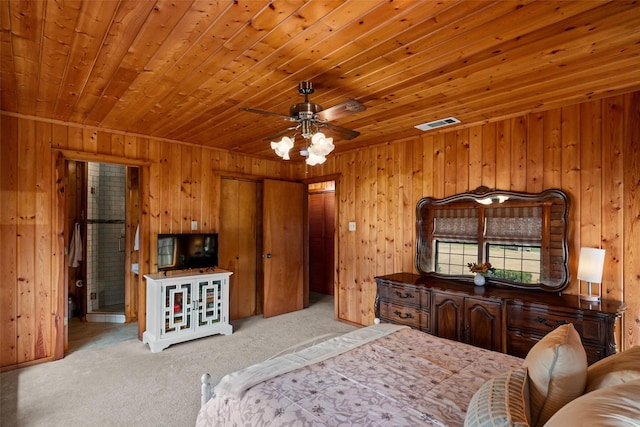 bedroom with carpet, wood ceiling, and wooden walls