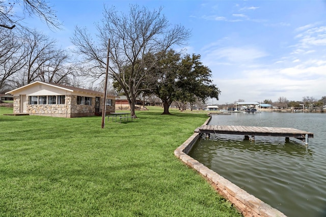 view of dock featuring a water view and a yard