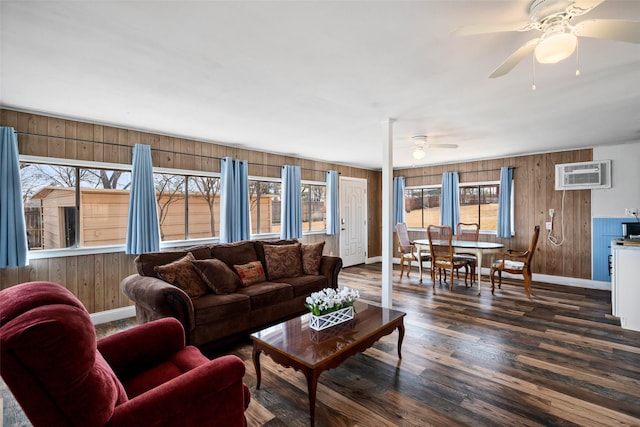 living room with wooden walls, baseboards, wood finished floors, and a wall mounted air conditioner