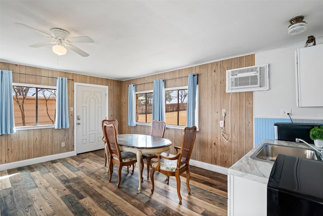 dining area with baseboards, a ceiling fan, and dark wood finished floors