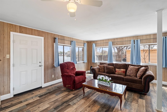 living area with wooden walls and wood finished floors