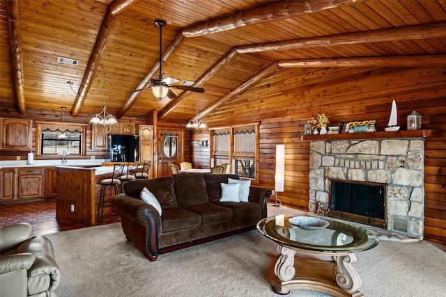 carpeted living area featuring wood ceiling, a fireplace, visible vents, and wooden walls