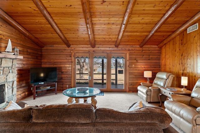 living room featuring wooden ceiling, carpet flooring, a fireplace, and lofted ceiling with beams