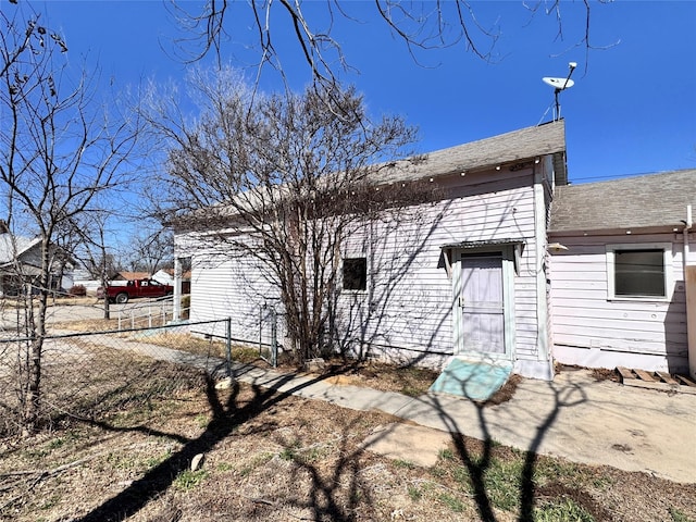 back of house featuring fence