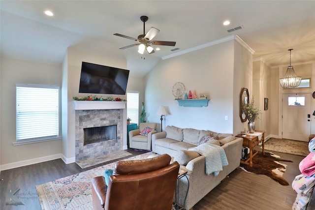 living room with dark wood-style flooring, a fireplace, visible vents, baseboards, and ornamental molding