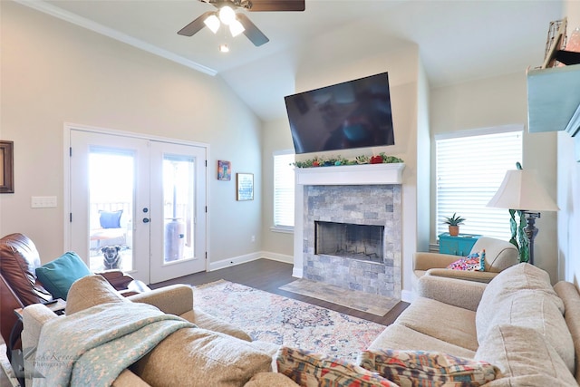 living area featuring baseboards, dark wood finished floors, french doors, lofted ceiling, and a stone fireplace