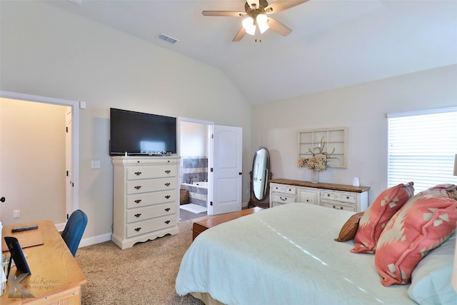 bedroom featuring lofted ceiling, light carpet, visible vents, baseboards, and ensuite bath