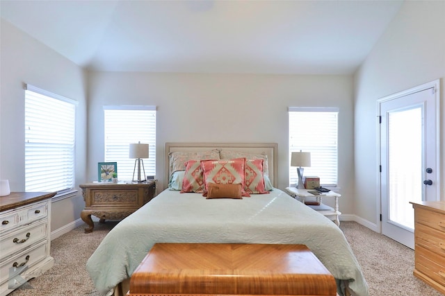 bedroom with baseboards and light colored carpet