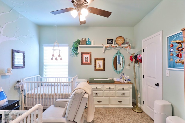 bedroom featuring a ceiling fan and a crib