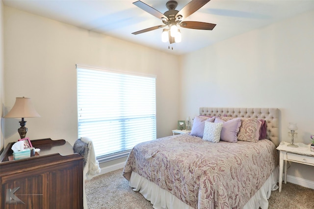 carpeted bedroom with ceiling fan and baseboards