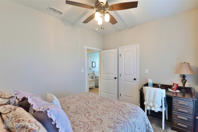 bedroom featuring carpet, visible vents, and a ceiling fan